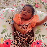 Miracle joined the competition — help win amazing prizes! baby, infant, child, cushion, floral_pattern, indoor, clothing, leopard_print, socks, top, lace, blanket, bed, person, cute, resting, soft_light, curly_hair, home, portrait