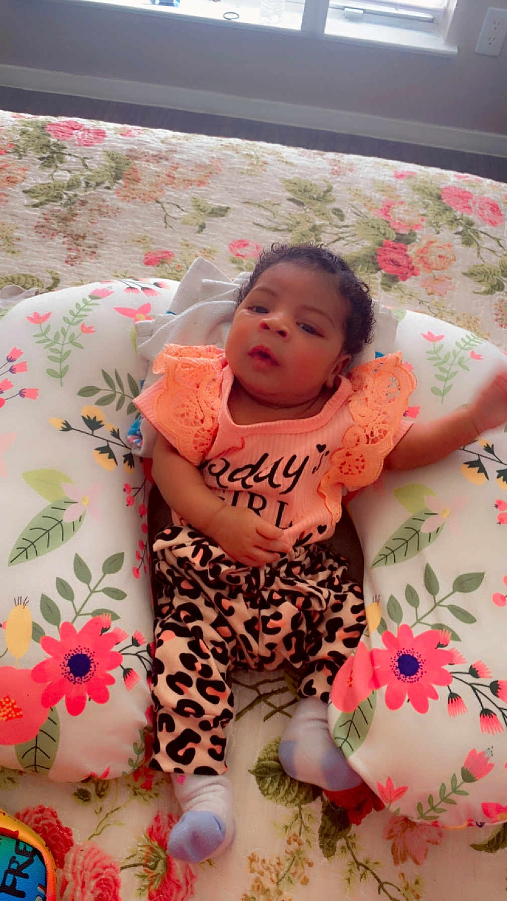 Miracle joined the competition — help win amazing prizes! baby, infant, child, cushion, floral_pattern, indoor, clothing, leopard_print, socks, top, lace, blanket, bed, person, cute, resting, soft_light, curly_hair, home, portrait