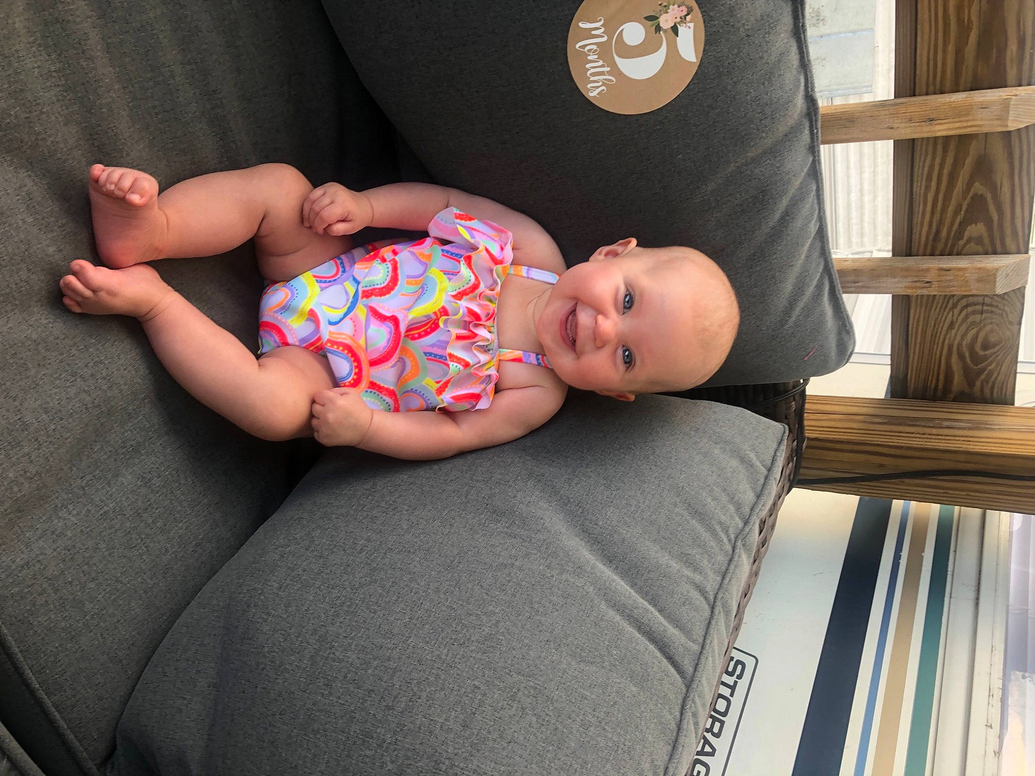 Rayleigh is registered to the contest to win money with this photo: baby, baby_products, baby_toddler_clothing, child, comfort, couch, finger, foot, fun, human_body, human_leg, joy, knee, pattern, person, room, sitting, sleeve, sock, thigh