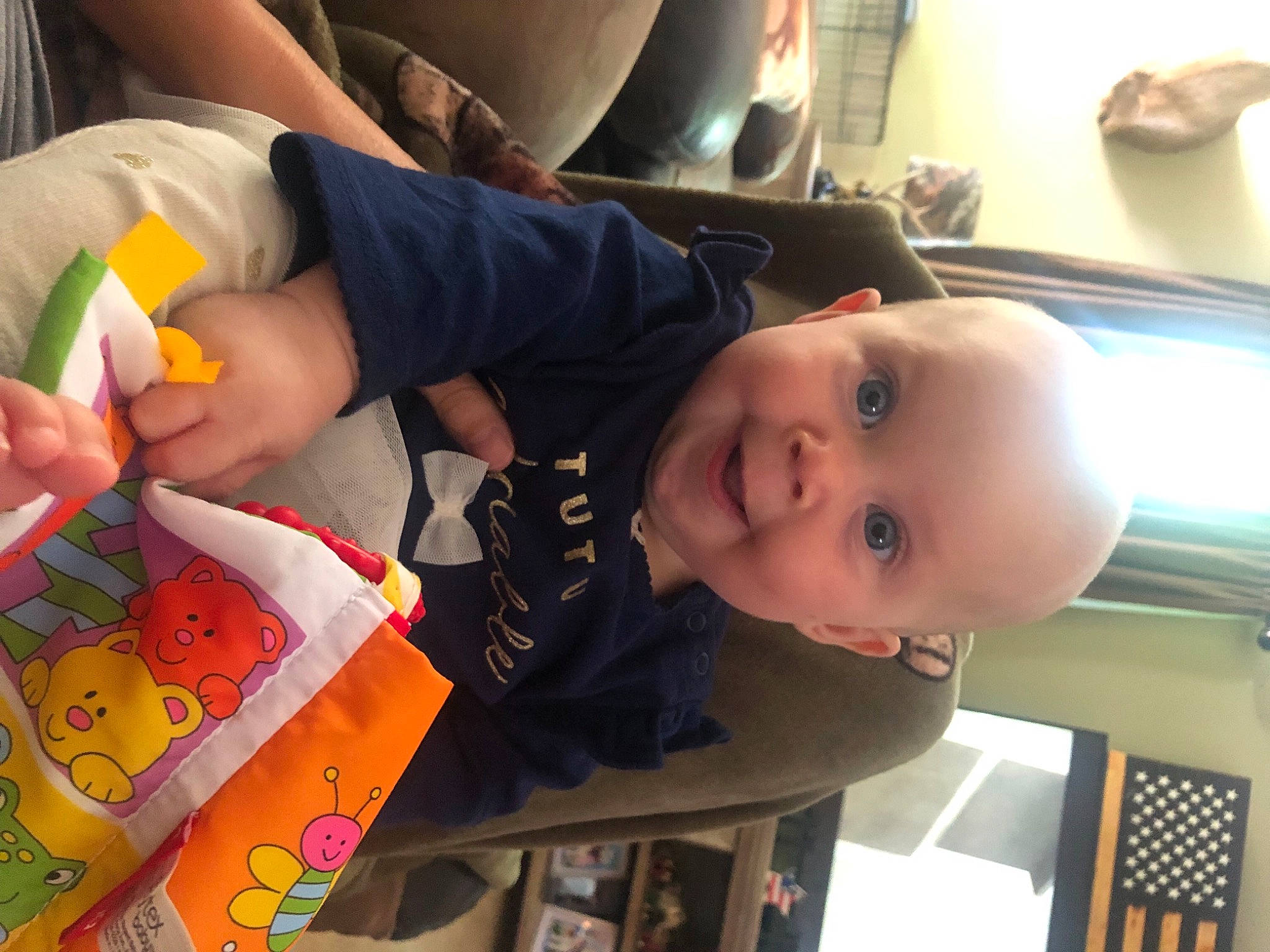Rayleigh is registered to the contest to win money with this photo: baby, baby_products, baby_toddler_clothing, blurred, cheek, child, facial_expression, finger, fun, happy, mouth, pattern, person, room, smile, t_shirt, thigh, toddler, toy