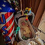 baby, stroller, toy, balloon, usa, porch, person, curtain, blanket, clothing, infant, relaxing, decor, sunlight, outdoor, celebration, colorful, happy, comfort, family