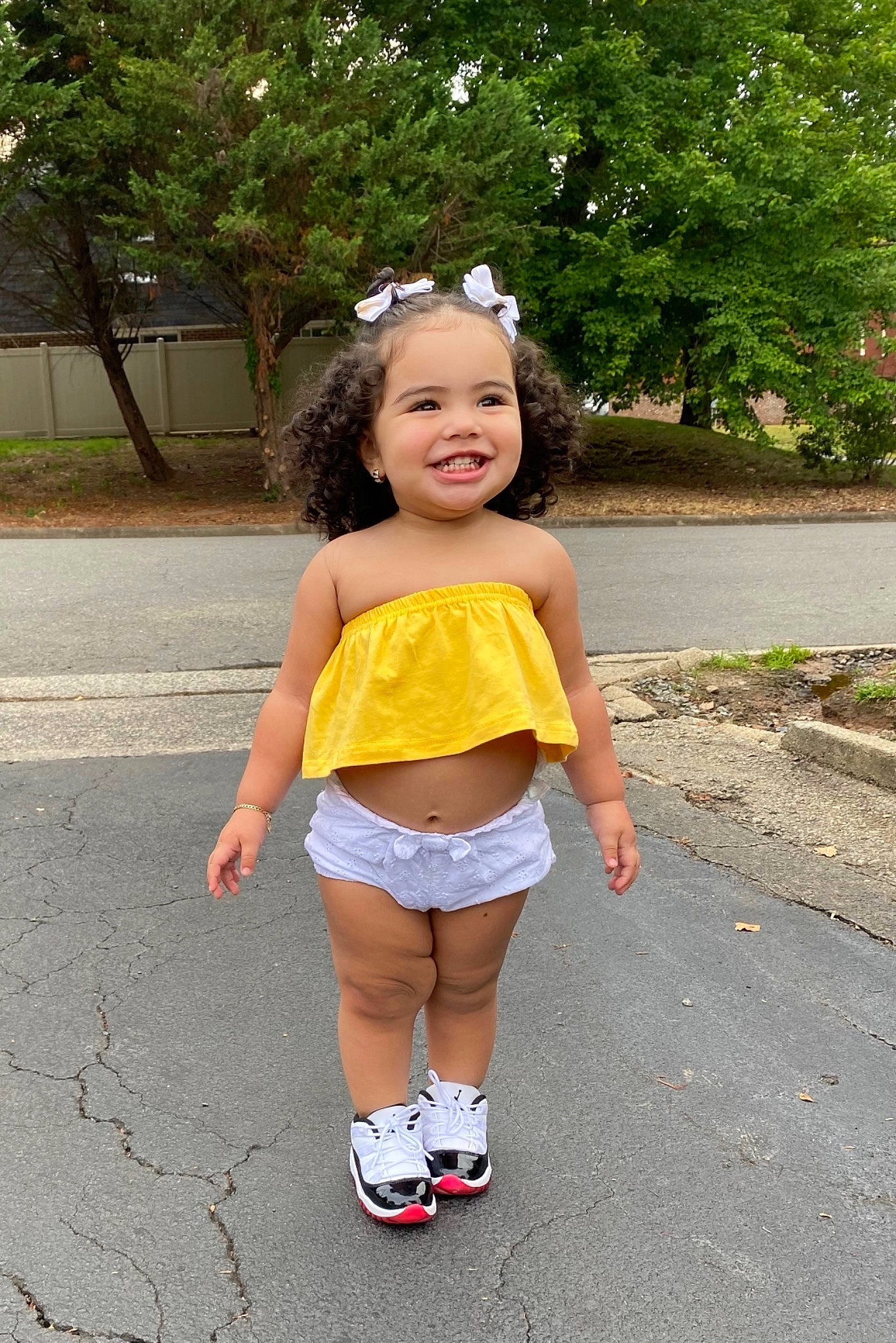 Kendra is registered to the contest to win money with this photo: asphalt, child, footwear, fun, happy, joy, person, play, shoe, shorts, smile, snapshot, summer, toddler, vacation, yellow