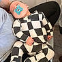 Pierson is registered to the contest to win money with this photo: baby, infant, sleeping, pacifier, onesie, checkered_pattern, black_and_white, cute, hand, arm, tattoo, carpet, door, zipper, legs, footed_pajamas, adult, portrait, indoor, cozy