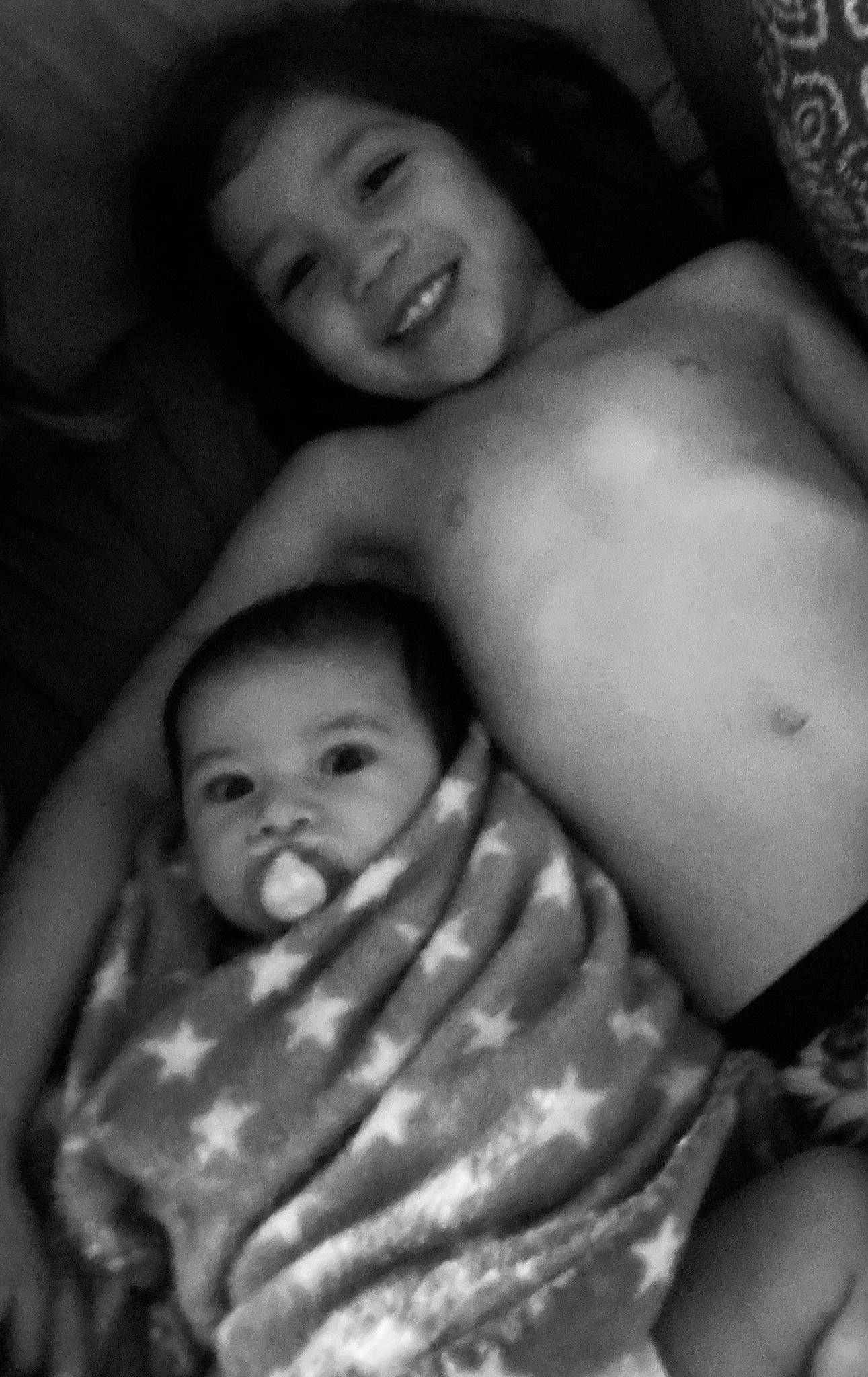 Nero is registered to the contest to win money with this photo: baby, black, black_and_white, cheek, comfort, eye, eyebrow, face, gesture, happy, joy, mouth, muscle, nose, organ, people, person, photograph, skin, smile