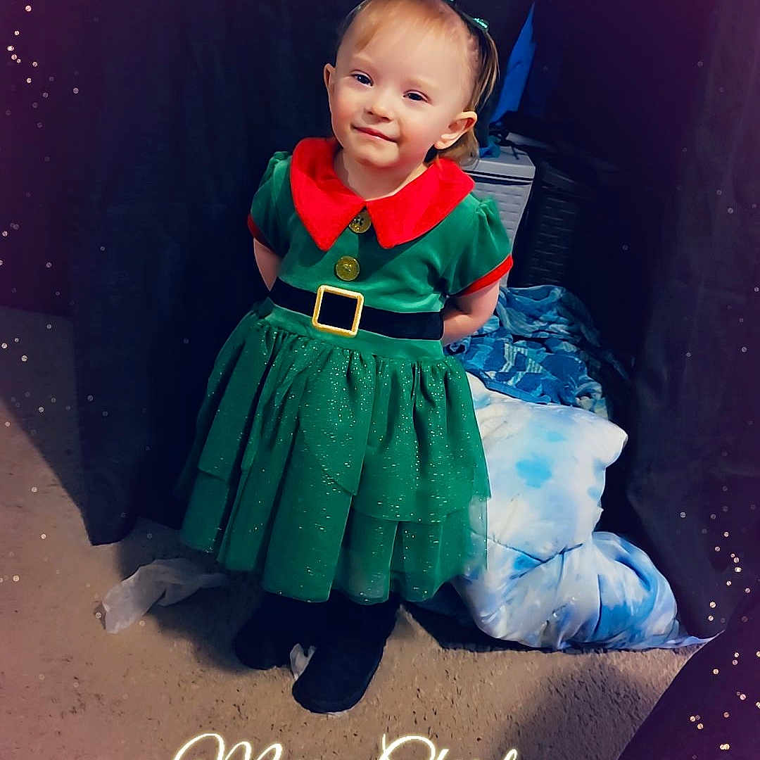 Nora is registered to the contest to win money with this photo: accessories, baby, belt, clothing, costume, dress, face, fashion, footwear, formalwear, glasses, head, indoors, jeans, outdoors, pants, person, photography, portrait, shoe