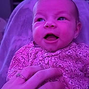 Abbi joined the competition — help win amazing prizes! baby, child, clothing, cute, face, hand, happy, holding, human, indoors, infant, newborn, patterned_outfit, person, portrait, purple_light, ring, skin, smile, soft