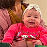 baby, child, smiling, headband, bow, pink_sweater, hello_kitty, adult, holding, indoor, portrait, happy, face, clothing, person, woman, sitting, warm_colors, cozy, casual