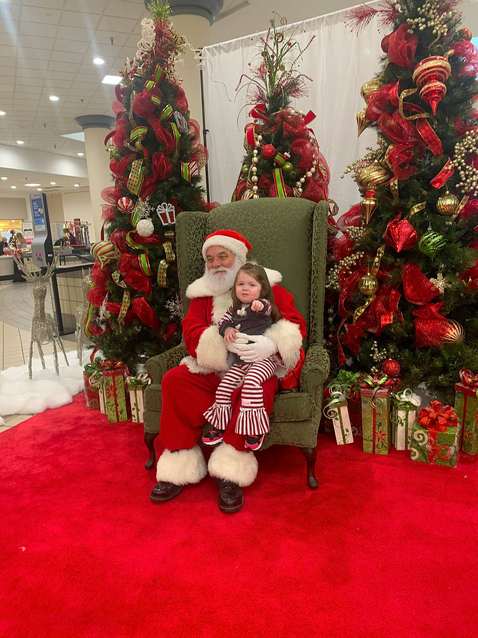 Addyson joined the competition — help win amazing prizes! christmas, christmas_decoration, christmas_eve, christmas_ornament, christmas_tree, event, fictional_character, floral_design, floristry, headwear, holiday, holiday_ornament, interior_design, person, plant, red, santa_claus, tradition, tree