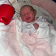 Olive joined the competition — help win amazing prizes! newborn, baby, blanket, smile, sleeping, pillow, floral_pattern, red_device, knitted, white_clothing, pink, infant, cute, wrapped, indoors, resting, baby_unit, soft, peaceful, child
