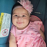 Isabella joined the competition — help win amazing prizes! baby, child, smile, pink_dress, headband, flower, car_seat, infant, cute, happy, portrait, watermelon_pattern, clothing, seatbelt, young_child, closeup, indoors, person, baby_girl, sitting