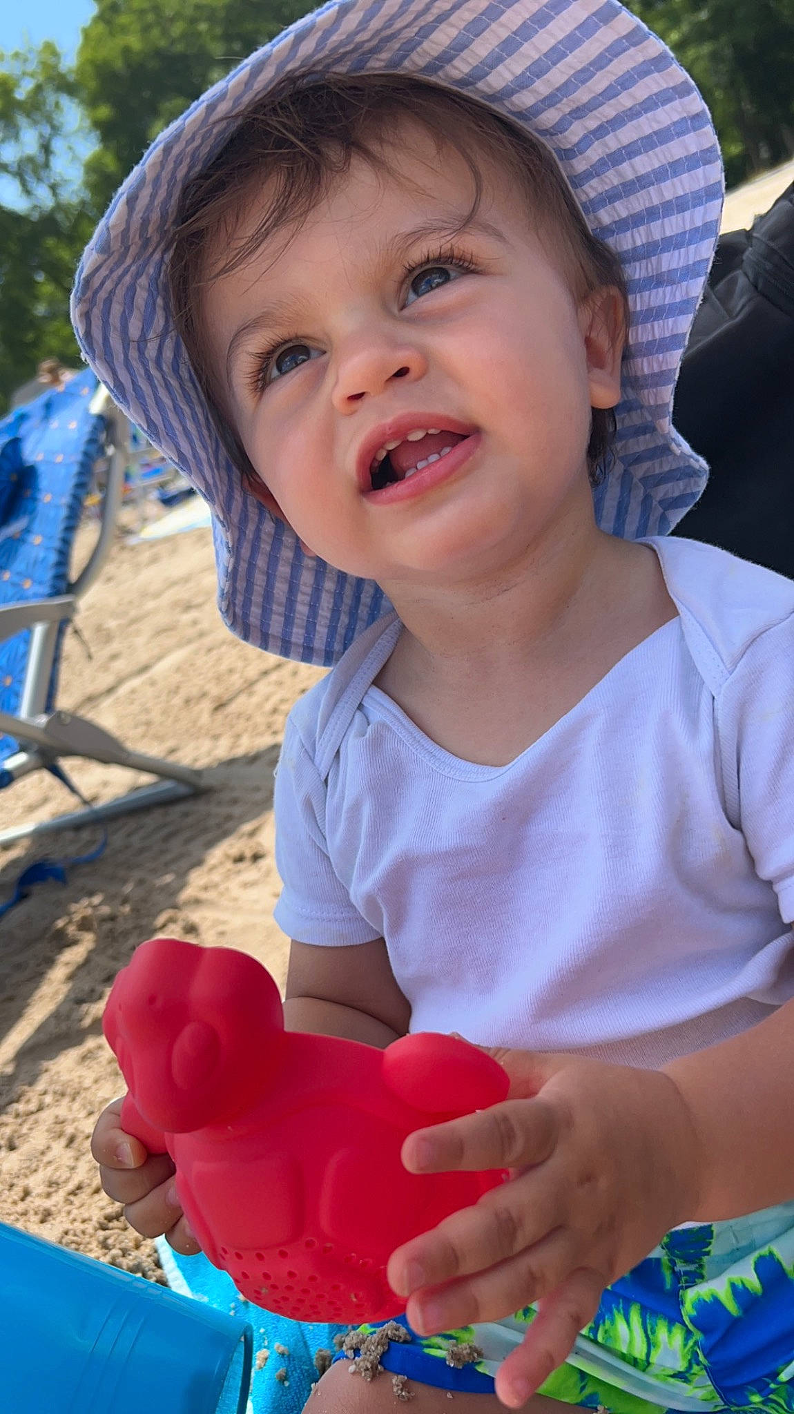 Luchiano is registered to the contest to win money with this photo: baby_toddler_clothing, blue, cap, child, facial_expression, finger, fun, happy, hat, leisure, organ, people, person, photograph, skin, smile, summer, sun_hat, toddler, toy