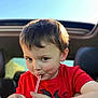 Sean is registered to the contest to win money with this photo: child, boy, drinking, straw, red_shirt, car_interior, sunlight, face, hands, cheeks, short_hair, seat, window, sky, casual, portrait, cute, young, indoors, happy