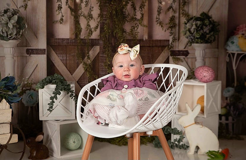 Gracelyn joined the competition — help win amazing prizes! baby, baby_products, baby_toddler_clothing, chair, child, doll, dress, fashion_accessory, flowerpot, furniture, head, houseplant, person, pink, plant, purple, room, sitting, toddler, toy