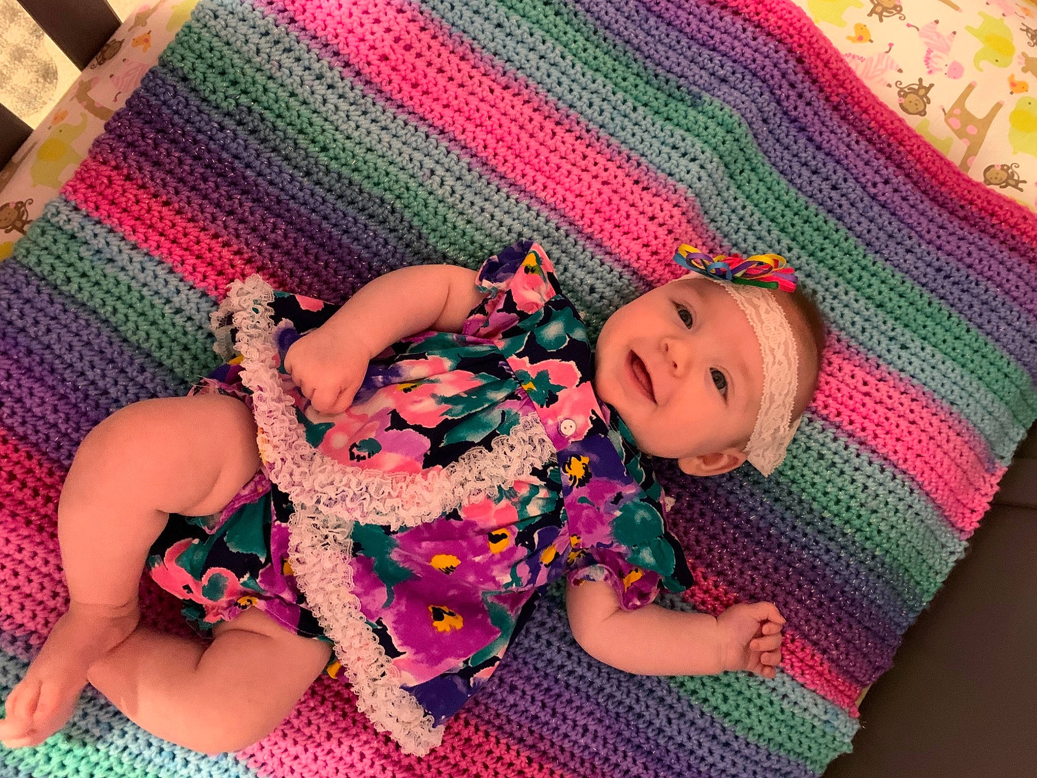 Gracelyn is registered to the contest to win money with this photo: arm, baby, baby_toddler_clothing, cheek, comfort, finger, green, hand, happy, head, headwear, human_body, leg, magenta, person, pink, purple, red, skin, textile