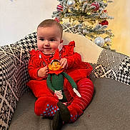 Talya participe au concours pour gagner de l'argent avec cette photo : armchair, baby, celebration, child, christmas_ornaments, christmas_tree, cute, decorations, elf_doll, festive, happy, holiday, holiday_lighting, indoors, patterned_fabric, red_clothing, seated, smiling, toddler, toy
