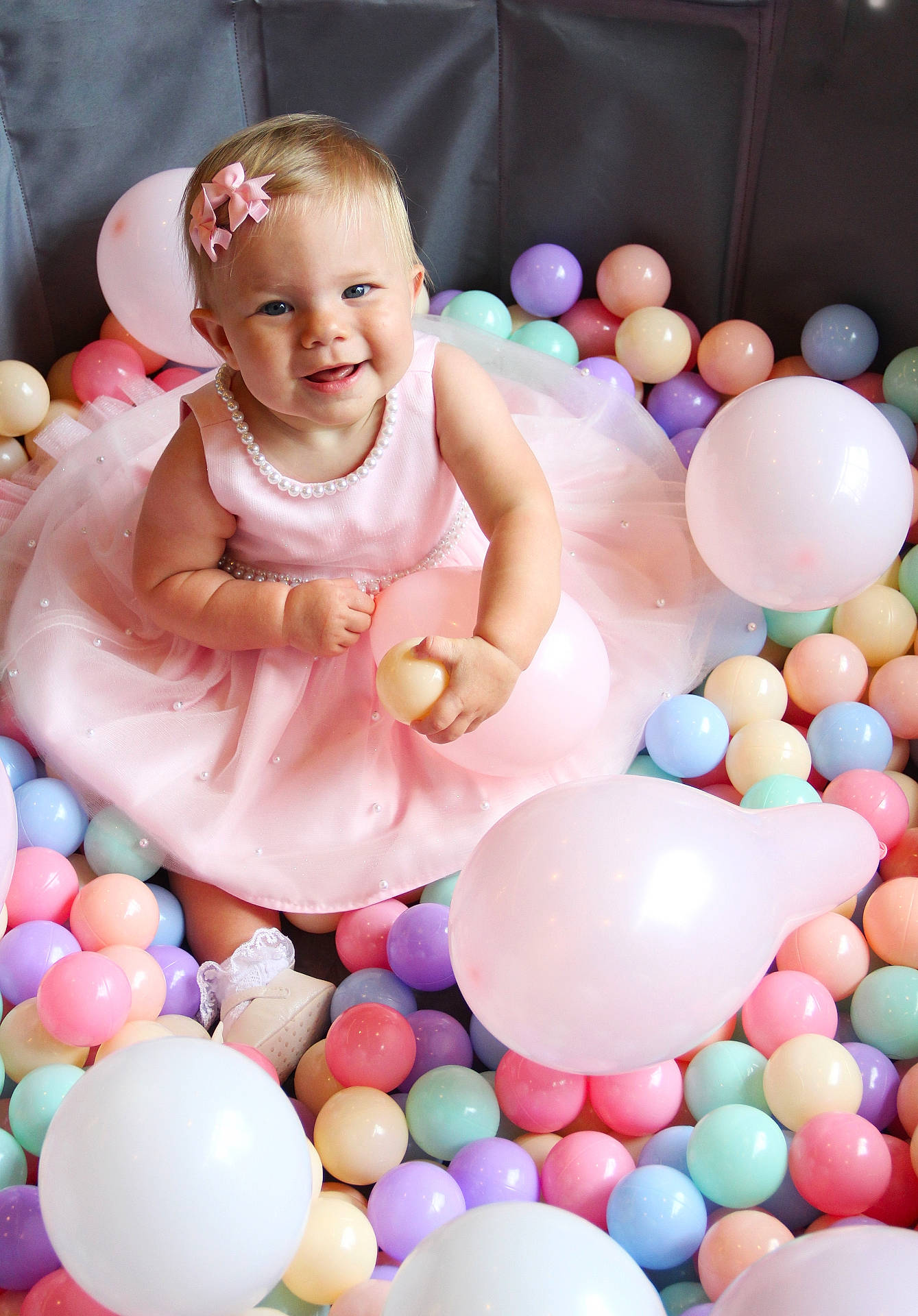 Eva joined the competition — help win amazing prizes! baby, ball_pit, balloons, bow, celebration, child, childhood, colorful_balls, cute, festive, fun, happy, indoor, joy, party, pearl_necklace, pink_dress, playtime, smiling, toddler