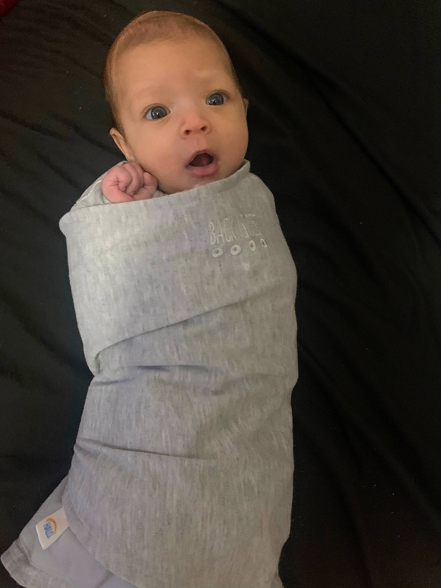 Felicity is registered to the contest to win money with this photo: baby, baby_products, baby_sleeping, baby_toddler_clothing, cheek, collar, comfort, eye, eyebrow, head, iris, linens, long_sleeved_t_shirt, neck, nose, outerwear, person, sitting, sleeve, t_shirt