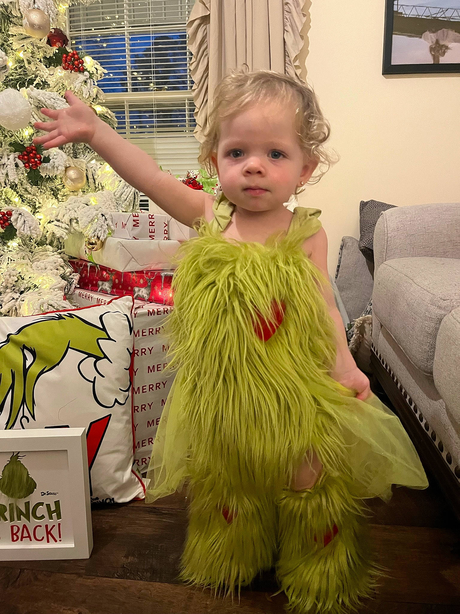 Brynlee is registered to the contest to win money with this photo: baby_toddler_clothing, child, costume, couch, event, fashion_design, flooring, fun, fur, happy, lighting_accessory, person, picture_frame, pink, plant, room, ruffle, sitting, toddler, tree