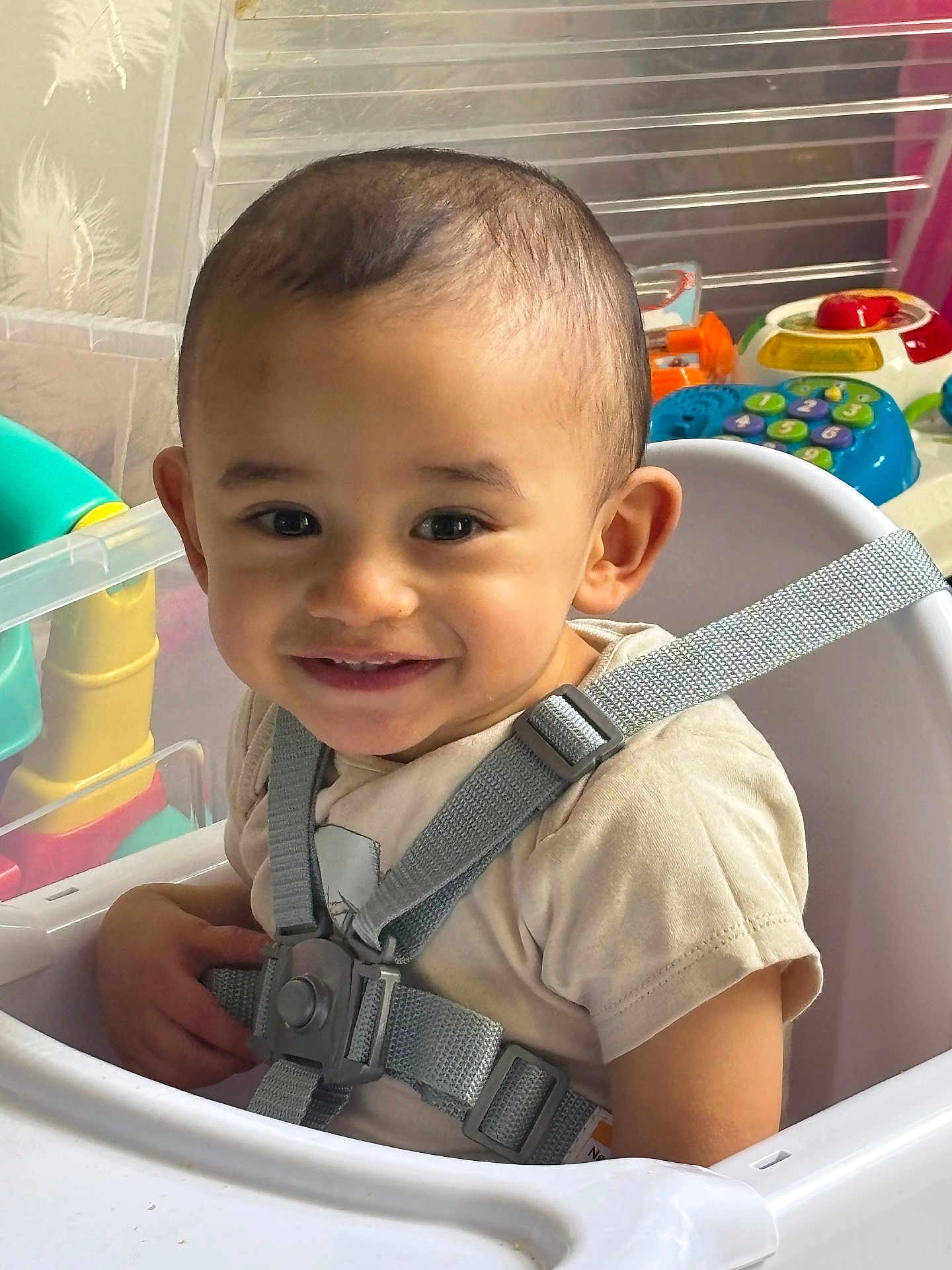 Shaam joined the competition — help win amazing prizes! toddler, child, high_chair, smiling, face, baby, seatbelt, toy, indoor, happy, person, clothing, playtime, closeup, cute, young_child, seat, infant, strap, safety