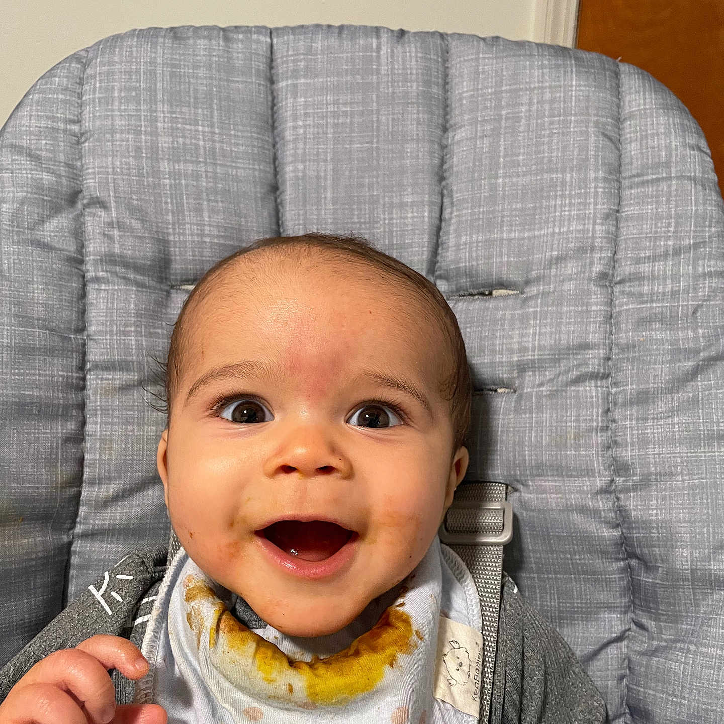 Robert is registered to the contest to win money with this photo: baby, bodypart, chair, clothing, coat, couch, cream, cutlery, eating, face, finger, food, furniture, hand, happy, head, person, photography, portrait, spoon
