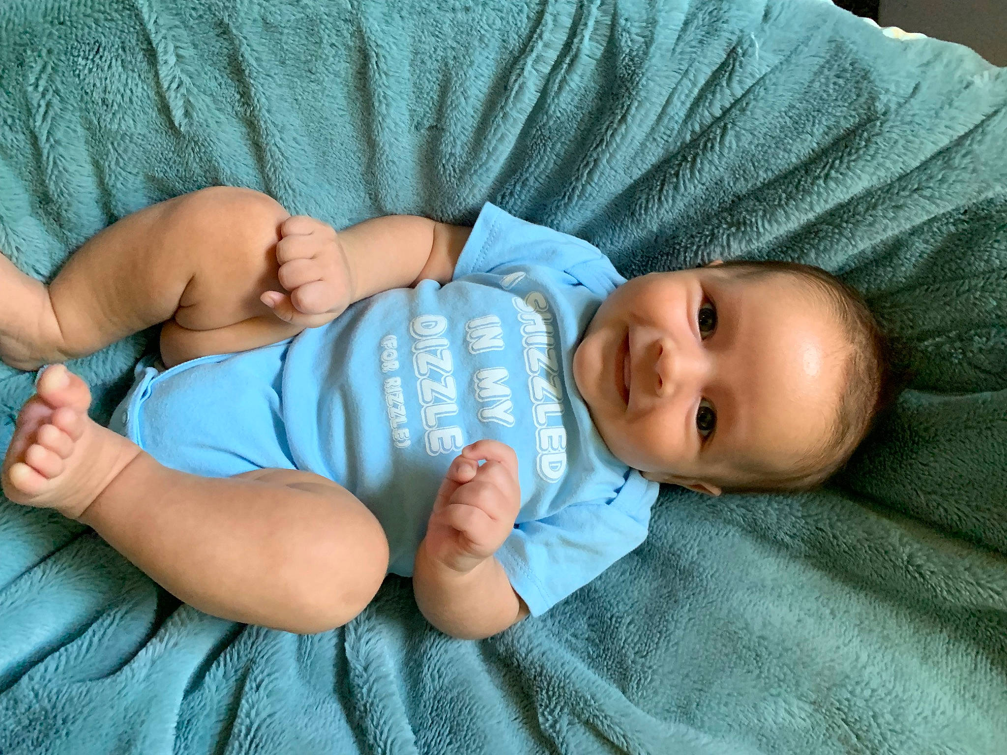 Kash is registered to the contest to win money with this photo: baby, baby_products, baby_toddler_clothing, cheek, child, comfort, eye, grass, hand, hat, joy, linens, pattern, person, product, room, sitting, skin, sleeve, smile