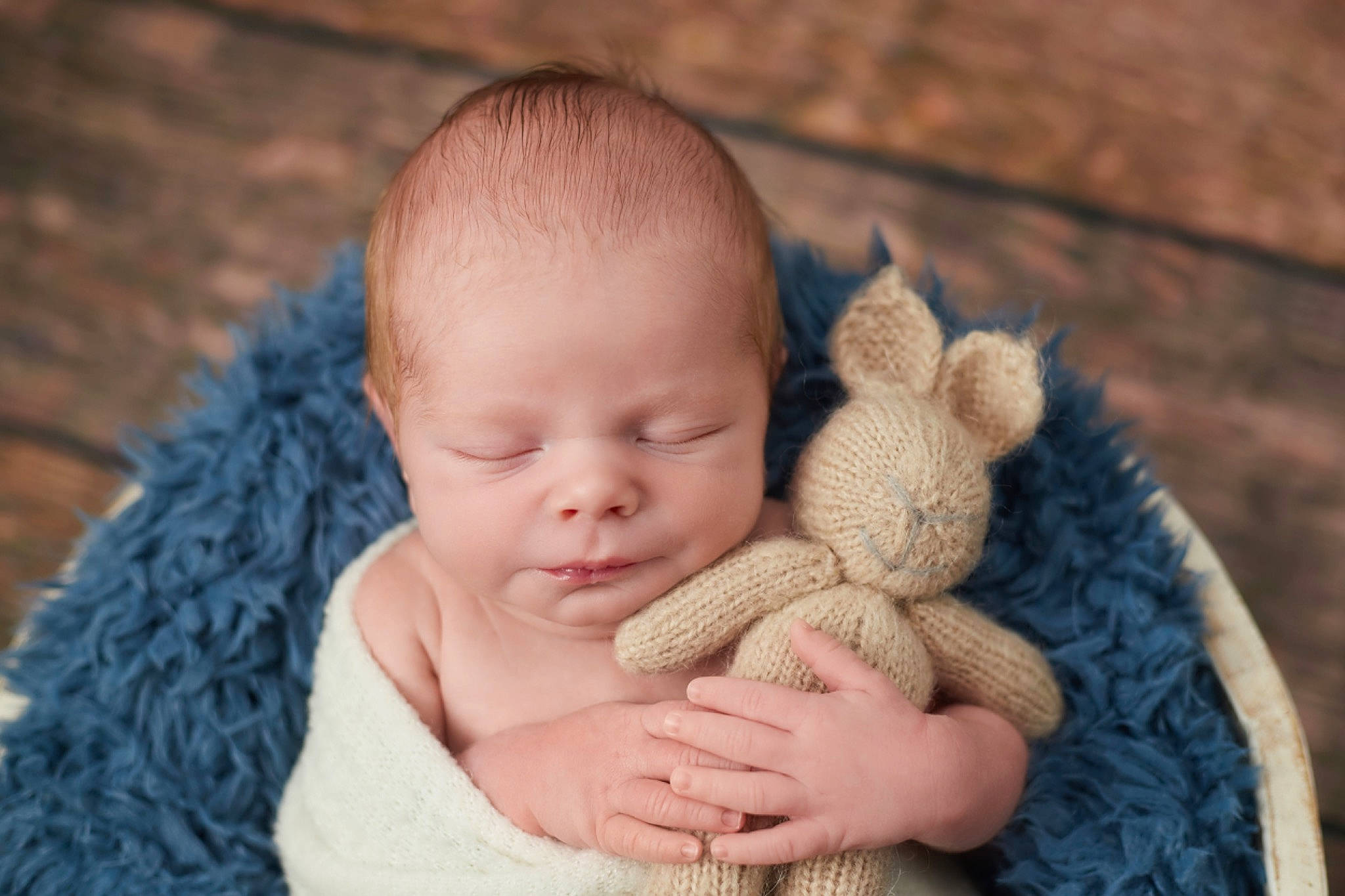 William is registered to the contest to win money with this photo: baby, baby_products, baby_toddler_clothing, child, comfort, finger, fur, grass, hand, happy, headgear, linens, nail, person, sitting, skin, textile, toddler, wood, wool