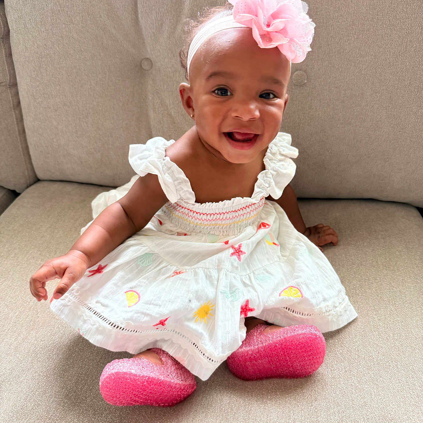 Miana joined the competition — help win amazing prizes! accessory, apparel, baby, child, couch, cute, dress, face, fashion, flower, happy, headband, indoors, infant, person, pink_shoes, portrait, seated, skin, smiling