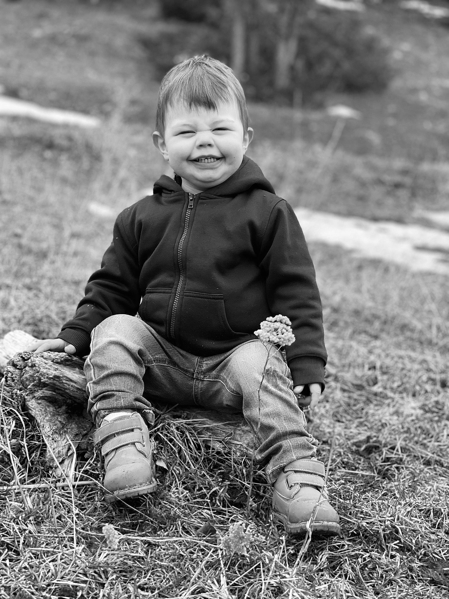 Luke is registered to the contest to win money with this photo: baby, baby_toddler_clothing, black_and_white, child, clothing, eye, face, flash_photography, grass, happy, head, joy, landscape, leg, monochrome, monochrome_photography, people_in_nature, person, plant, smile