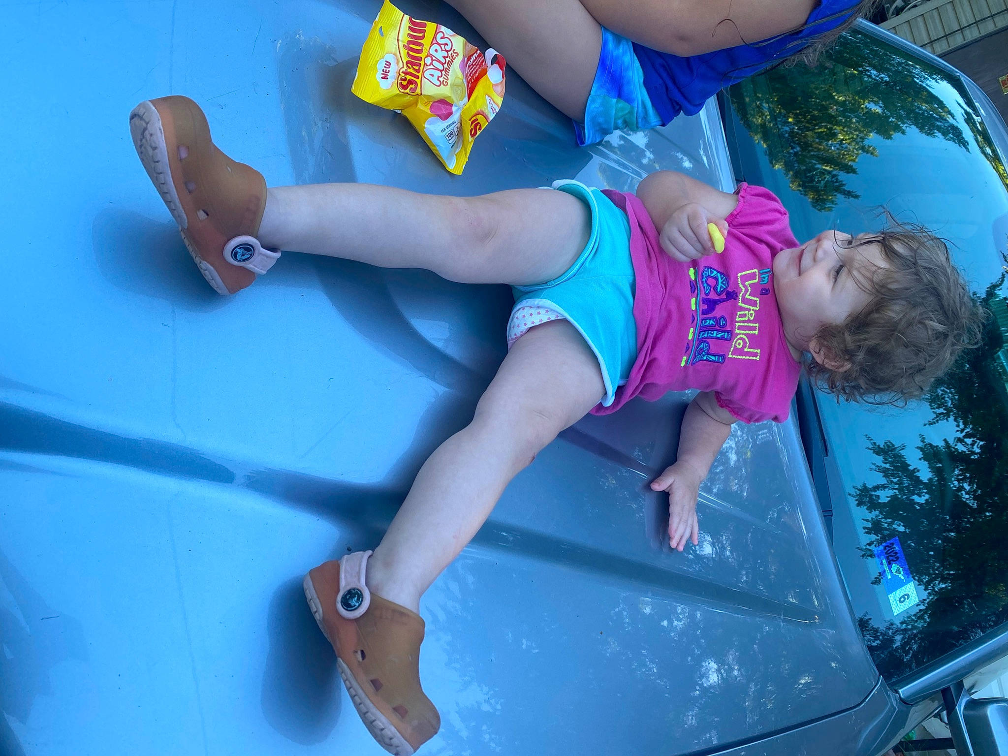 Lexi is registered to the contest to win money with this photo: azure, barefoot, blue, electric_blue, foot, fun, green, happy, human_leg, knee, leisure, person, recreation, sandal, shorts, sportswear, sunglasses, t_shirt, thigh, waist