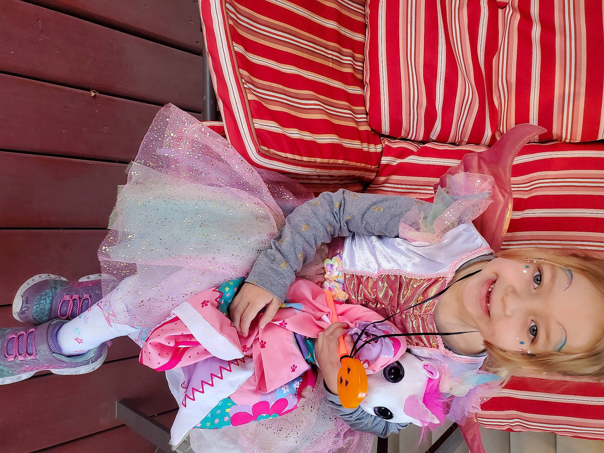 Willow is registered to the contest to win money with this photo: baby_products, baby_toddler_clothing, carmine, child, costume, fashion_accessory, fun, happy, joy, magenta, pattern, peach, person, pink, room, sitting, smile, textile, toddler, toy