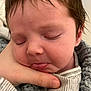 baby, infant, sleeping, face, hand, tongue, blanket, striped_clothing, closeup, soft_texture, peaceful, skin, hair, newborn, person, portrait, resting, cozy, indoor, cute