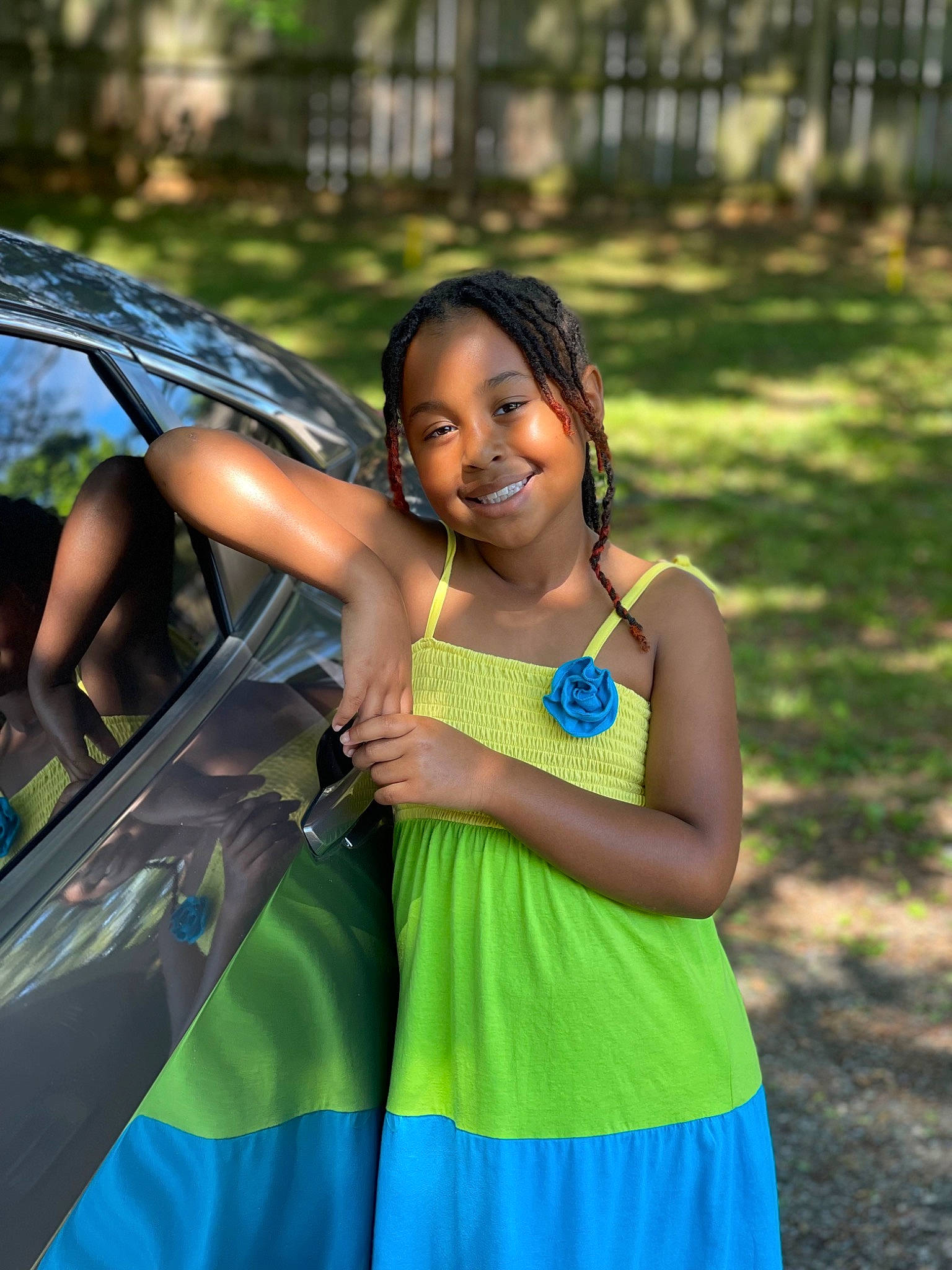 Skyrah is registered to the contest to win money with this photo: abdomen, automotive_design, automotive_exterior, child, clothing, event, facial_expression, fun, grass, happy, hood, joy, leisure, motor_vehicle, person, recreation, shoulder, smile, summer, t_shirt