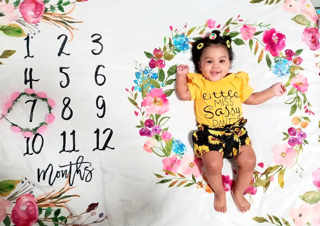 Sahara is registered to the contest to win money with this photo: baby_toddler_clothing, cut_flowers, event, facial_expression, floral_design, flower, flower_arranging, font, happy, joy, magenta, morning, people_in_nature, person, petal, pink, plant, sleeve, smile, t_shirt