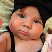 Cataleya participe au concours pour gagner de l'argent avec cette photo : baby, infant, headband, black_bow, close_up, face, cheeks, eyes, skin, clothing, blanket, pacifier, soft, cute, portrait, child, indoors, expression, newborn, person