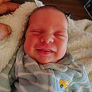 John joined the competition — help win amazing prizes! newborn, baby, smile, face, hand, blanket, onesie, striped, cozy, sleepy, infant, cute, soft, closeup, person, child, indoor, warm, happy, tiny