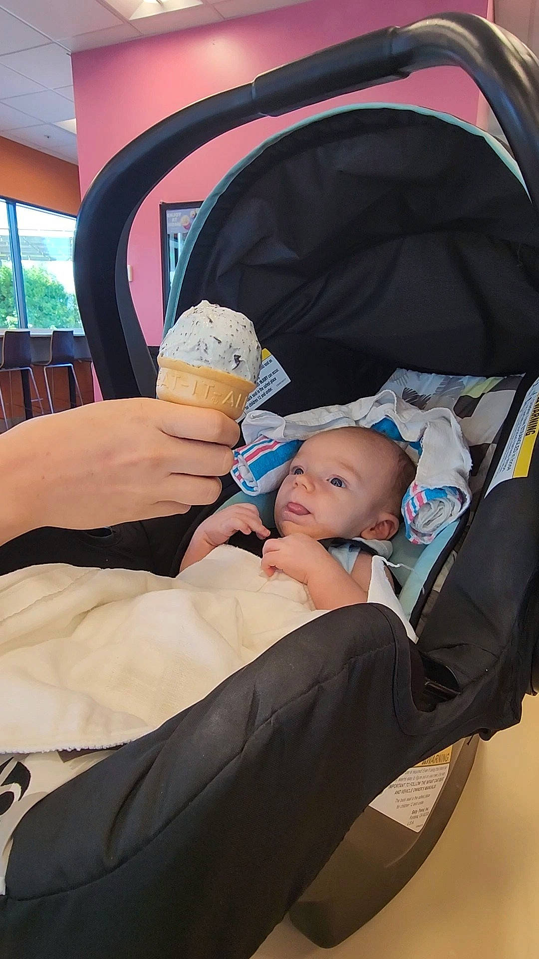 Bear is registered to the contest to win money with this photo: baby, baby_carriage, baby_products, baby_safety, chair, child, comfort, event, fashion_accessory, fun, hand, hat, headgear, human_body, leisure, person, sitting, smile, thumb, toddler