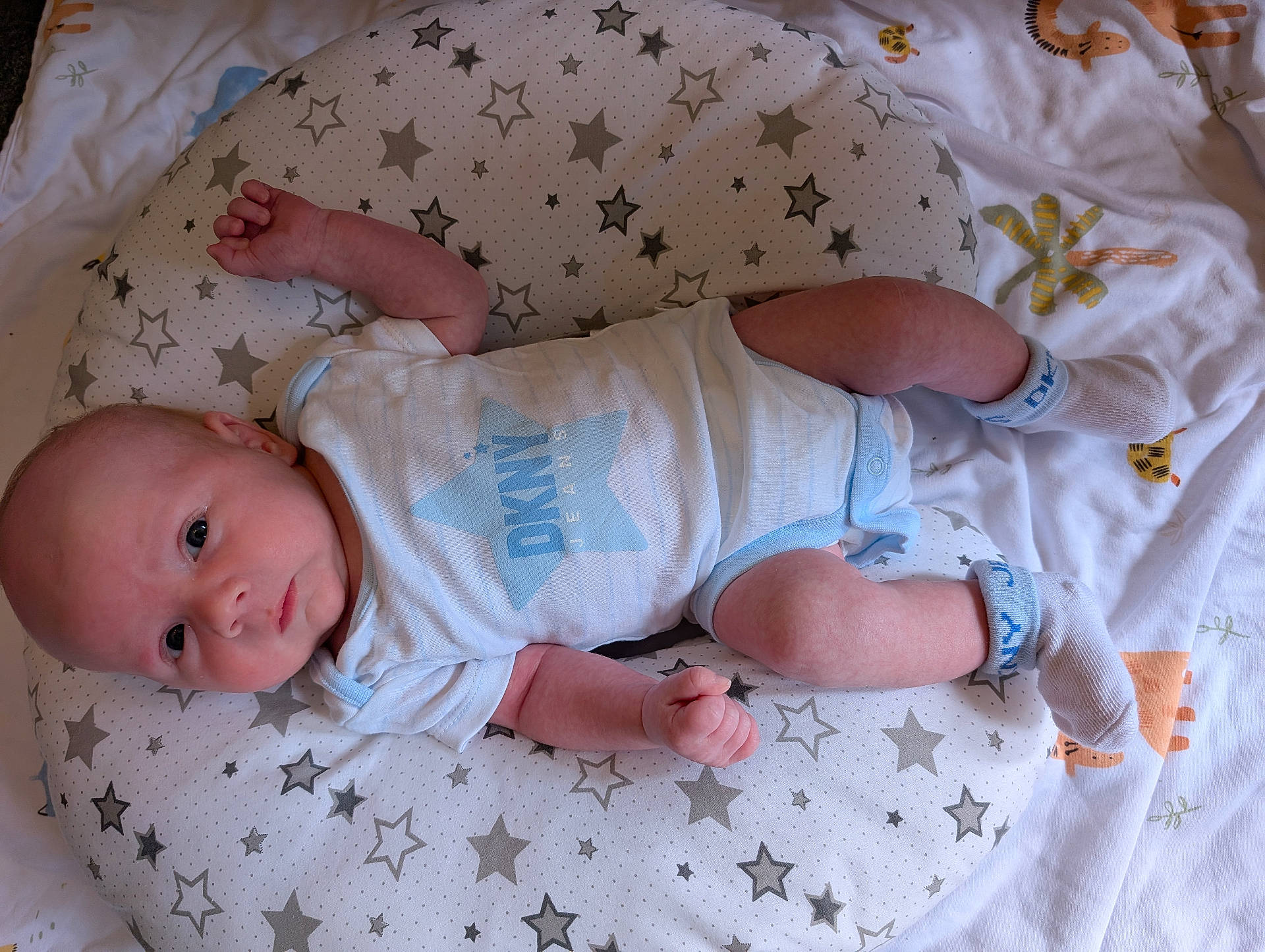 Jonyk joined the competition — help win amazing prizes! animal_prints, baby, blanket, child, curious_expression, cute, face, foot, hand, indoors, infant, lying_down, newborn, onesie, pillow, relaxed, skin, socks, soft_fabric, stars