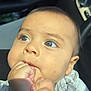 baby, child, face, hand, fist, blue_eyes, skin, clothing, car_interior, seat, sunlight, closeup, infant, cute, portrait, young_child, expression, human, skin_tone, sitting