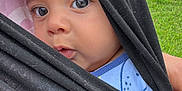Asvel Navarrete joined the competition — help win amazing prizes! baby, child, face, eyes, black_cloth, wrap, outdoor, grass, park, person, infant, closeup, portrait, curious, head, skin, blue_clothing, hand, daylight, nature