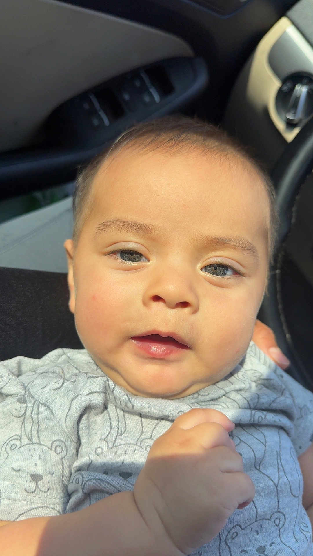 Asvel Navarrete is registered to the contest to win money with this photo: baby, infant, face, close_up, onesie, clothing, hand, car_interior, seat, sunlight, cute, child, portrait, skin, expression, person, eyebrows, nose, mouth, head