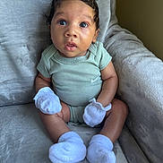 Reign joined the competition — help win amazing prizes! baby, blue_eyes, child, comfortable, curly_hair, cute, expression, indoors, infant, looking_up, mittens, onesie, person, plush_chair, portrait, seated, skin, socks, soft_fabric, young_child