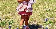 Dixie is registered to the contest to win money with this photo: child, toddler, toy, stuffed_animal, purple, flowers, bluebonnets, field, grass, outdoor, sunny, smiling, red_barn, people, sky, nature, summer, casual_clothing, pink_shoes, happy