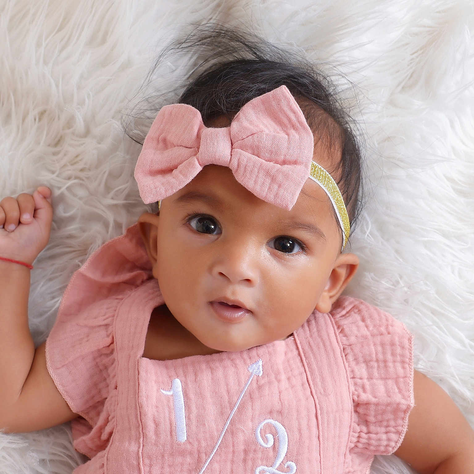Dixie joined the competition — help win amazing prizes! adorable, baby, child, close_up, curious_expression, cute, eyes, face, fluffy_background, hand, headband, indoor, infant, lying_down, person, pink_bow, pink_outfit, portrait, soft_texture, young_child