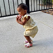 Dixie joined the competition — help win amazing prizes! toddler, child, smiling, clapping, yellow_outfit, colorful_shoes, outdoor, concrete_floor, metal_fence, happy, cute, playful, person, young_child, short_hair, earrings, daylight, side_view, joyful, small_child