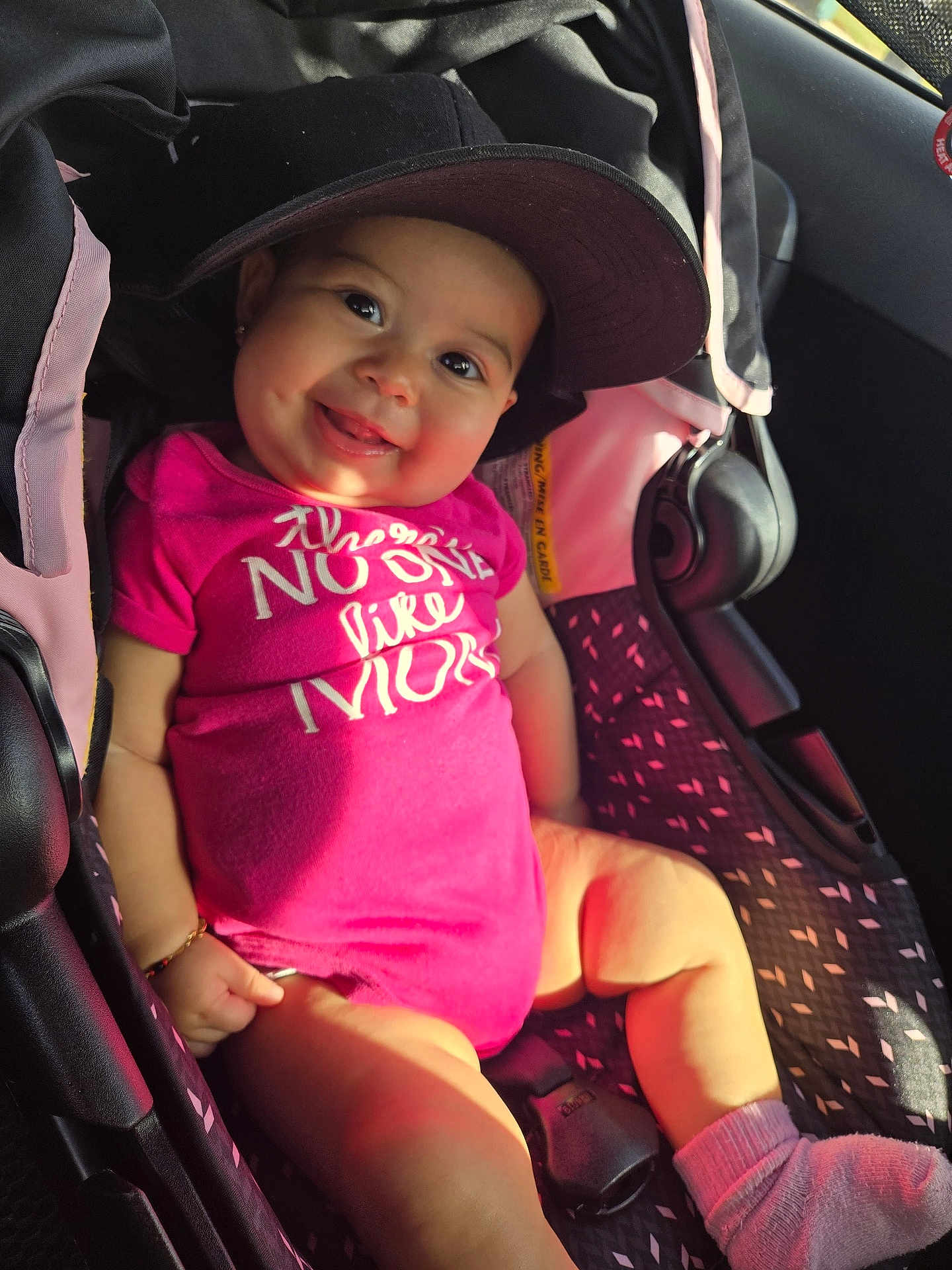 Kaori Hinata joined the competition — help win amazing prizes! baby, child, car_seat, cap, pink_outfit, smiling, tongue_out, socks, sunlight, seatbelt, infant, cute, portrait, happy, indoor, person, seat, clothing, headwear, car_interior