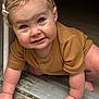 baby, child, crawling, headband, blue_eyes, brown_clothing, doorway, hands, floor, indoor, closeup, cute, infant, person, skin, smiling, young_child, portrait, happy, natural_light