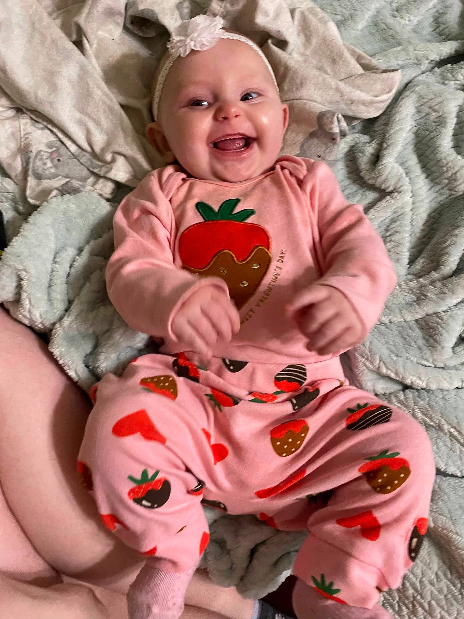 Sabrina is registered to the contest to win money with this photo: arm, baby, baby_toddler_clothing, cheek, comfort, dress, eye, face, happy, head, human_body, leg, orange, person, pink, skin, sleeve, smile, textile, toddler