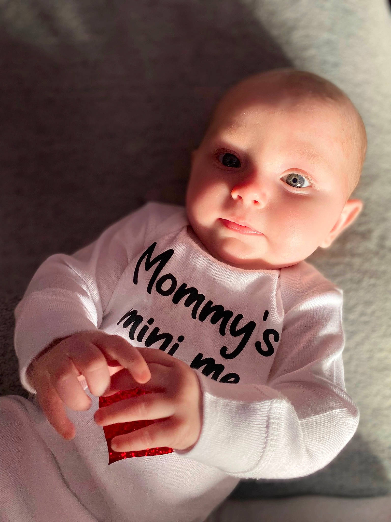 Sabrina is registered to the contest to win money with this photo: baby, baby_toddler_clothing, cheek, chin, comfort, cool, eye, eyebrow, facial_expression, finger, flash_photography, gesture, hairstyle, lip, mouth, neck, nose, person, skin, sleeve