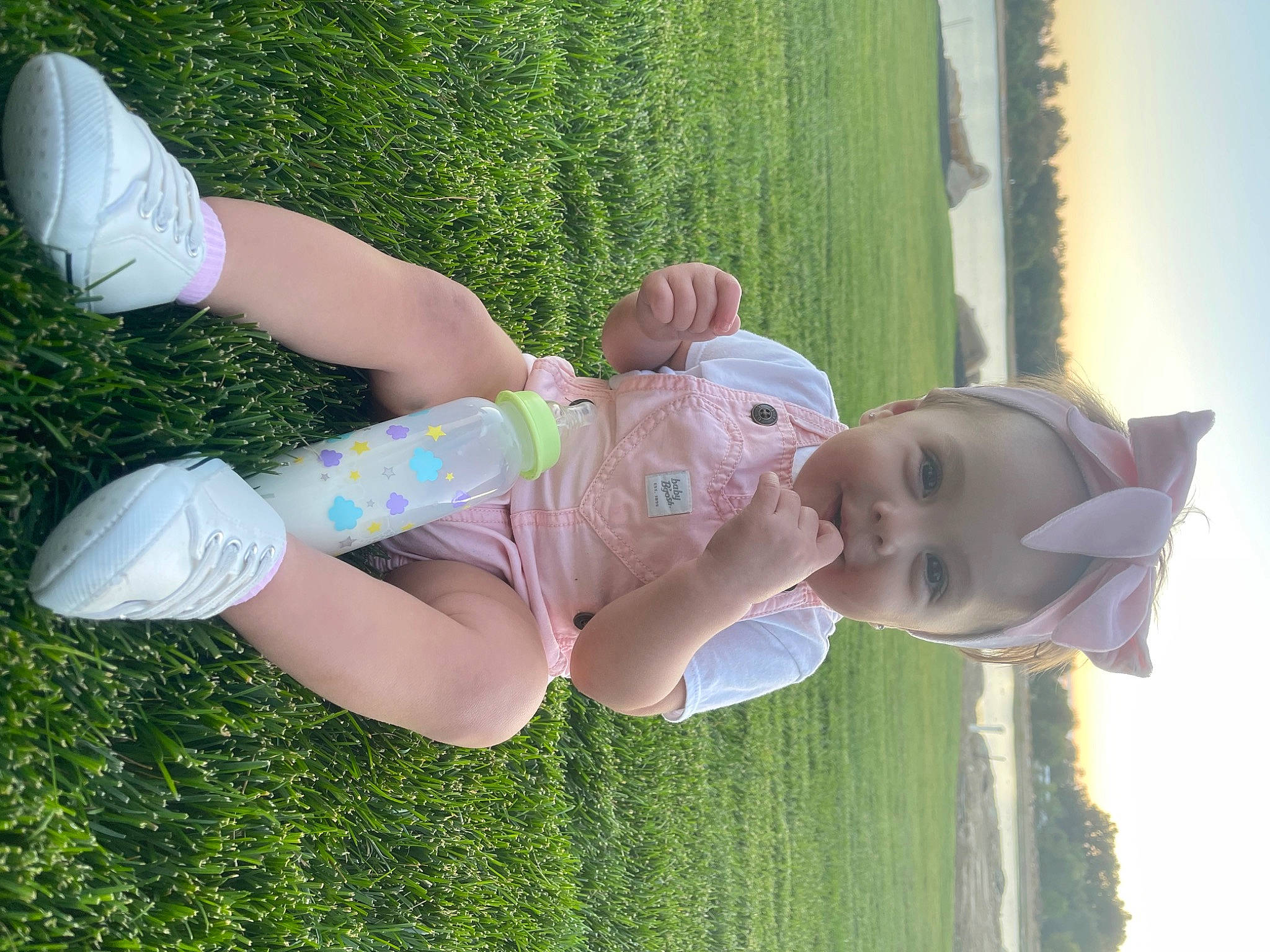 Brylee joined the competition — help win amazing prizes! baby, baby_toddler_clothing, child, finger, fun, gesture, grass, grass_family, green, happy, human_leg, joy, lawn, leisure, people_in_nature, person, plant, sky, smile, thigh