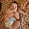 Learick Lee joined the competition — help win amazing prizes! baby, blanket, chewing, child, clothing, comfort, cute, expression, face, floral, foot, head, indoors, infant, lying_down, pattern, playing, skin, toddler, warm